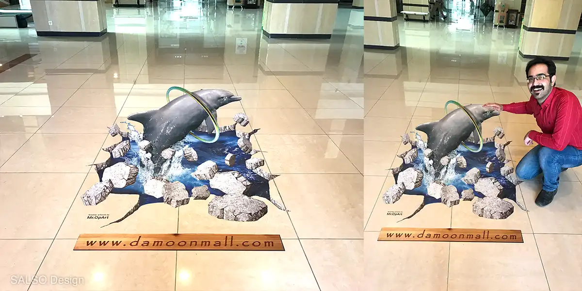 A dolphin jumps into the ring from a hole on the floor